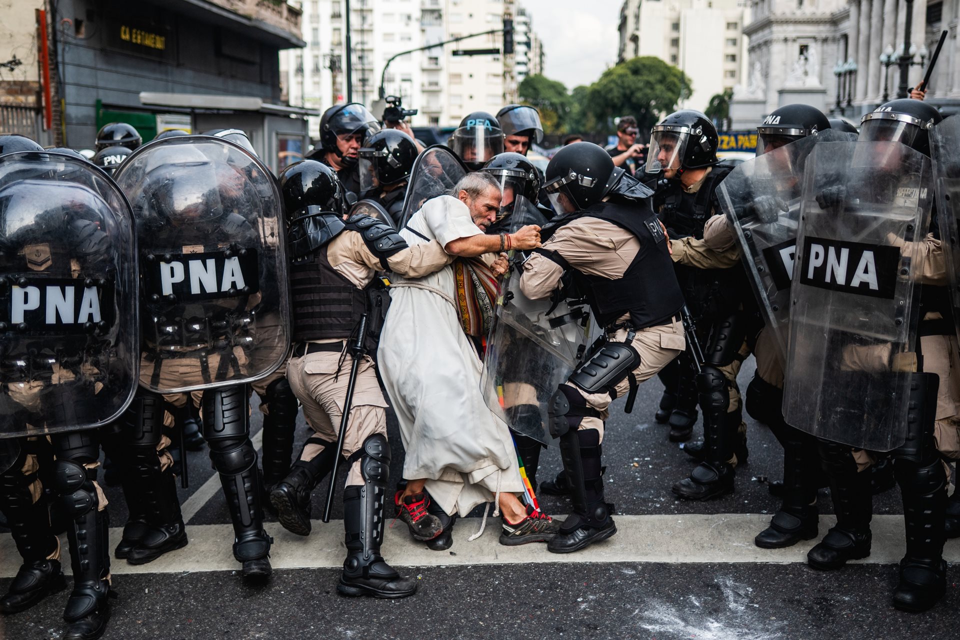 Police detain Father Jorge &ldquo;Chueco&rdquo; Romero during a pensioners&rsquo; protest in Buenos Aires, Argentina. Members of the &ldquo;Opción por los Pobres&rdquo; (Option for the Poor) clergy have joined weekly demonstrations against pension freezes and cuts to essential medical coverage. While Romero was thrown to the ground, he was later released.